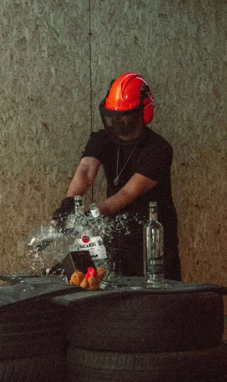 Person smashing bottles wearing safety gear